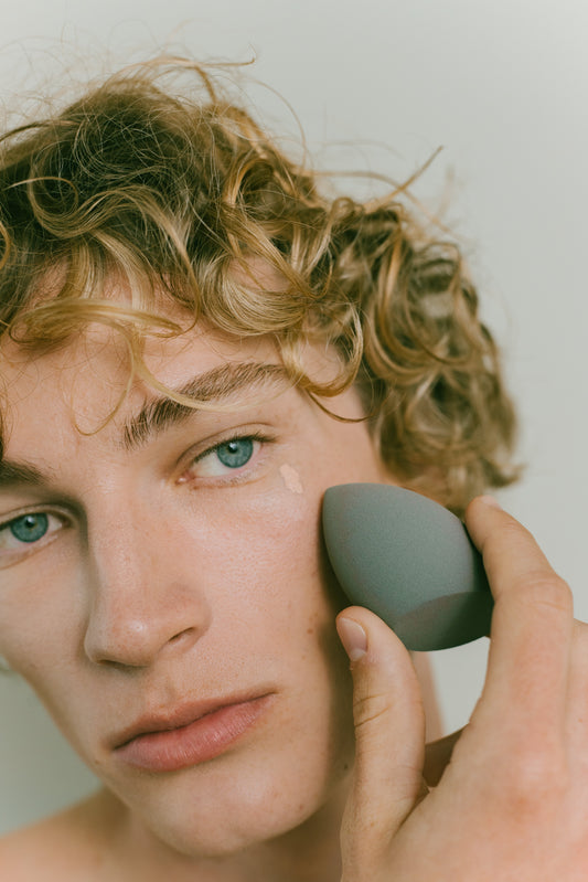 Image of a man applying Kint Concealer.